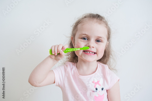 Girl cleans her teeth in the morning