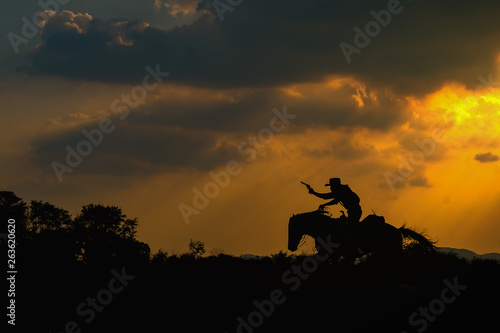 Cowboy silhouette on a horse during nice sunset