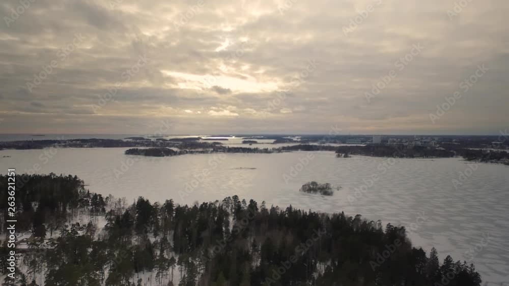 Aerial drone shot depicting the sheer mass and size of a frozen lake in Northern Finland during the winter season. Aerial drone shot depicting the sheer mass and size of a frozen lake in Northern Finland during the winter season.