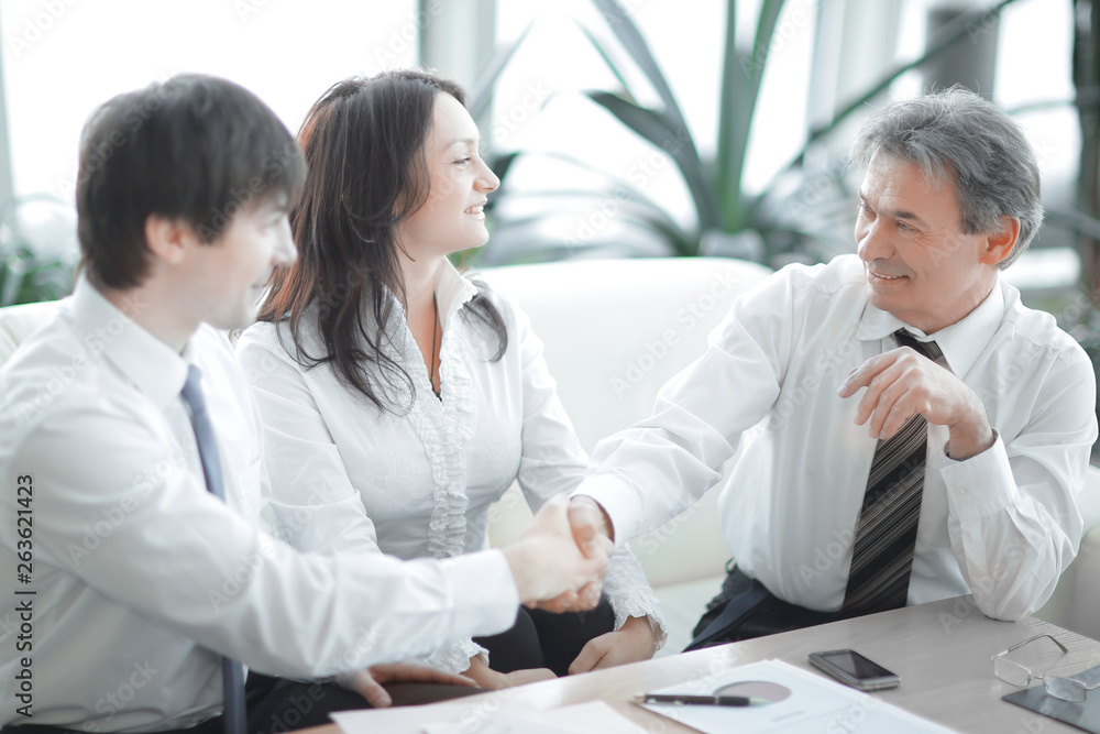 closeup.the financial partners shaking hands over Desk closeup.the financial partners shaking hands over Desk