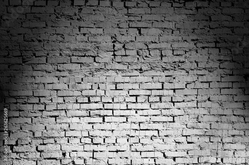 Black and white brick wall lighted from above