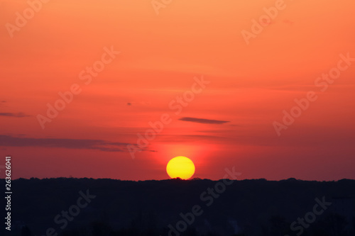 Flaming sky with sunrise Close-up. Romantic rising sun on the horizon