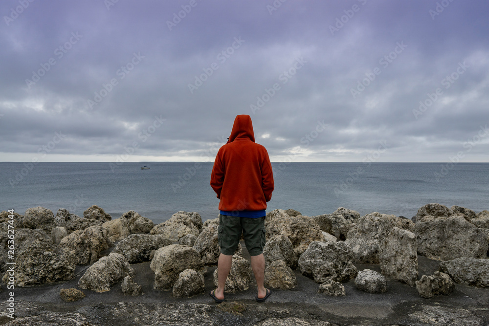 Man in deep thought looking over ocean Man in deep thought looking over ocean