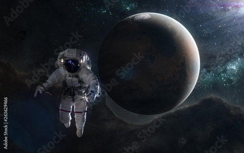 Fototapeta Naklejka Na Ścianę i Meble -  Astronaut and red planet in blue rays. Mars, Solar System. Science fiction art. Elements of the image were furnished by NASA