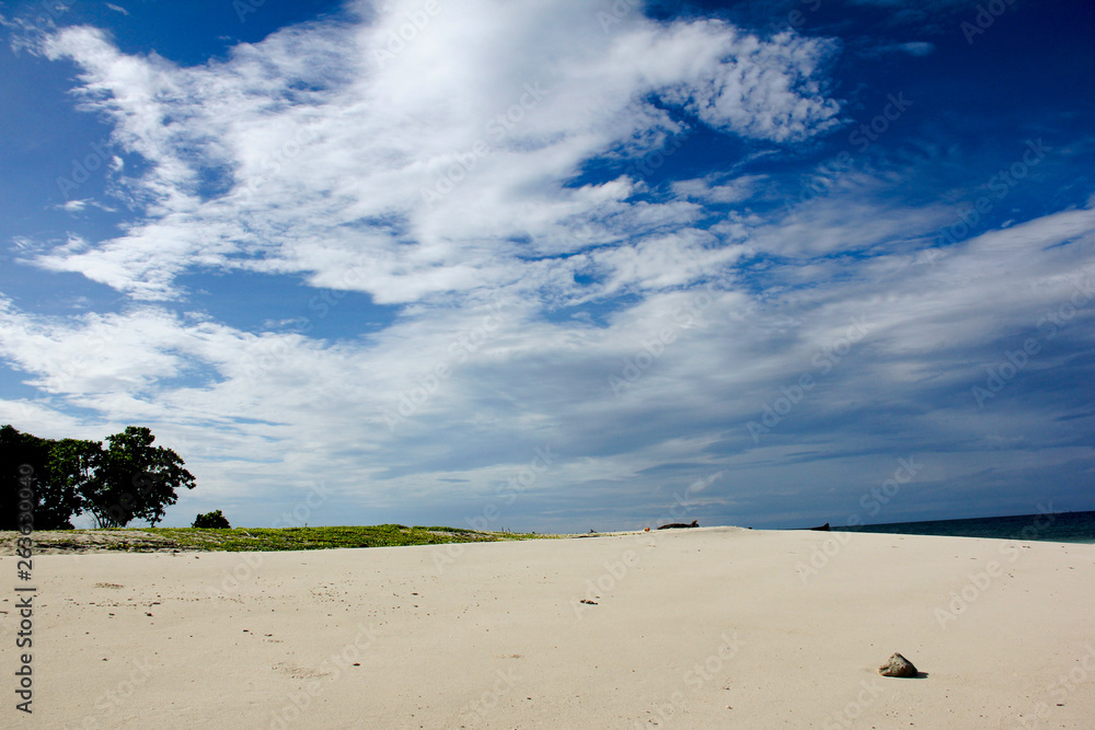 The white sand beach in Andaman sea with blue sky background in summer. The white sand beach in Andaman sea with blue sky background in summer.