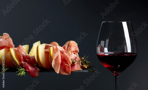 Red wine with prosciutto and melon.