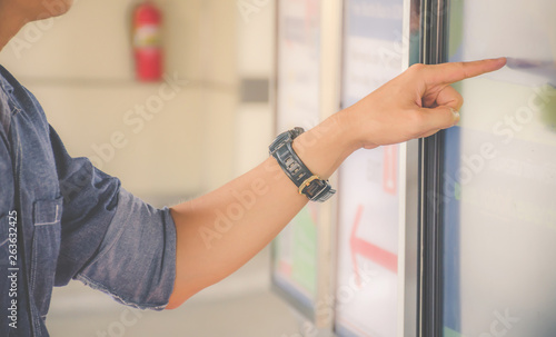 Closeup hand of a man pointing finger to screen  large display of a orders food in the touch screen terminal or in the electronic menu in the restaurant