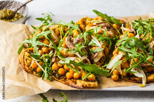 Green vegan pizza with pesto, chickpeas, champignons and arugula. photo