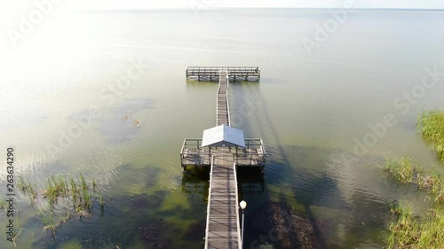 Flying over a Florida lakeside dock on a beautiful, calm Spring Evening photo