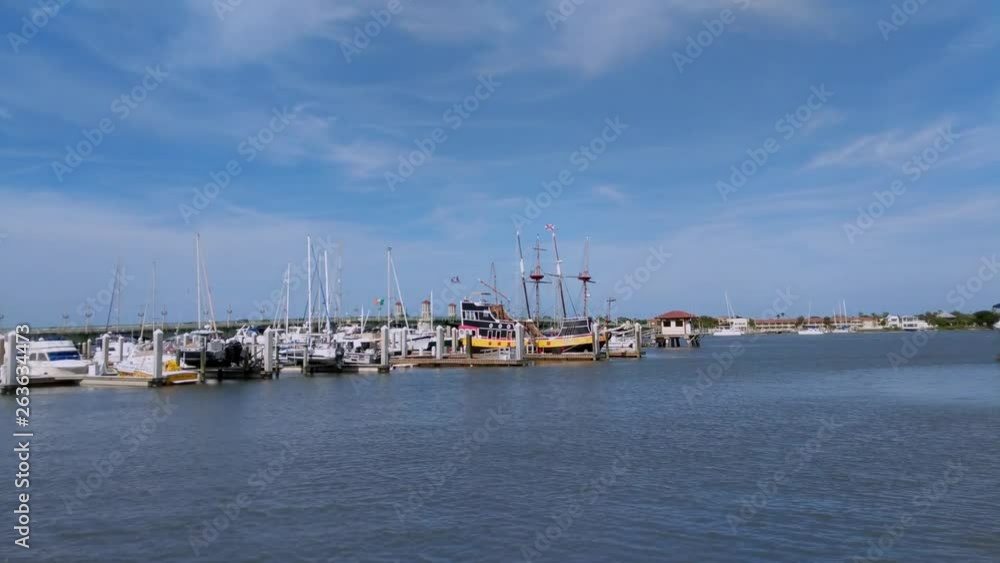 Panning up from the sea to reveal sailboats and a pirate ship in the St. Augustine Marina. Panning up from the sea to reveal sailboats and a pirate ship in the St. Augustine Marina.