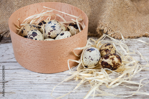 Quail eggs in small wooden box and beside to her