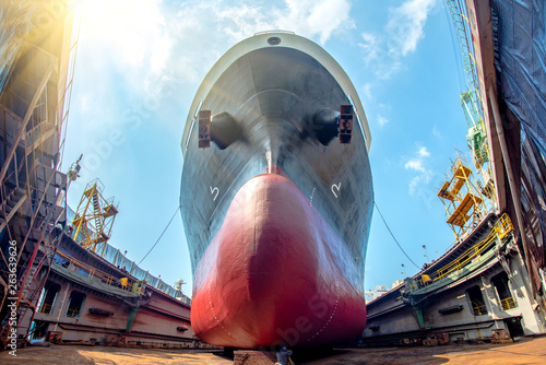 bulk head of the commercial ship in floating dry dock for painting , repairing, recondition, sand blasting of overhaul, ship sitting on supporter bottom layer of dry dock terminal