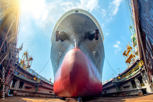 bulk head of the commercial ship in floating dry dock for painting , repairing, recondition, sand blasting of overhaul, ship sitting on supporter bottom layer of dry dock terminal photo