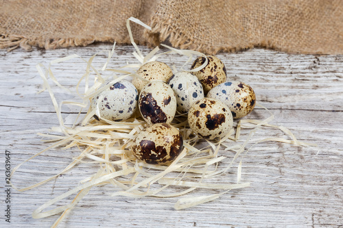 Quail eggs on an old wooden surface