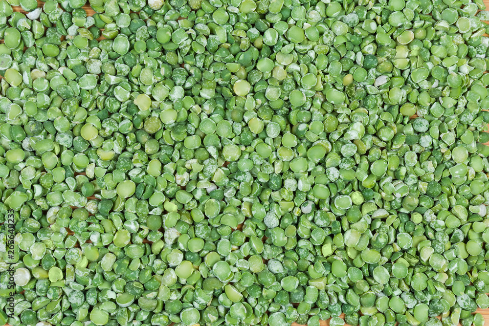 Background of the green split peas on a wooden surface Background of the green split peas on a wooden surface