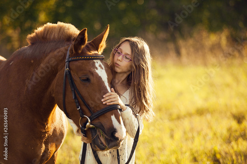 Young girl with horse in field