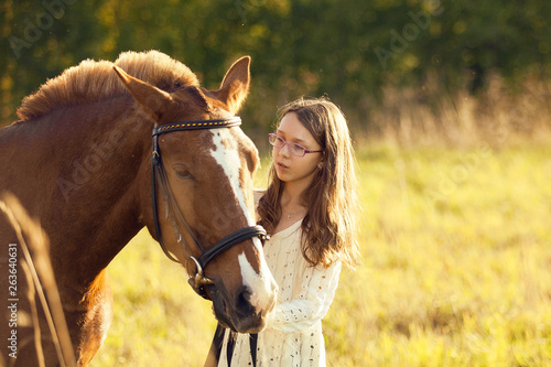 Young girl with horse in field