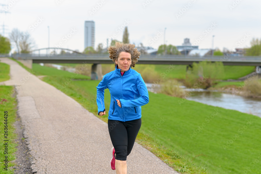Fit athletic middle-aged woman jogging