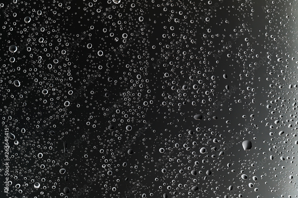 Obraz premium black wet background / raindrops for overlaying on window, concept of autumn weather, background of drops of water rain on glass transparent