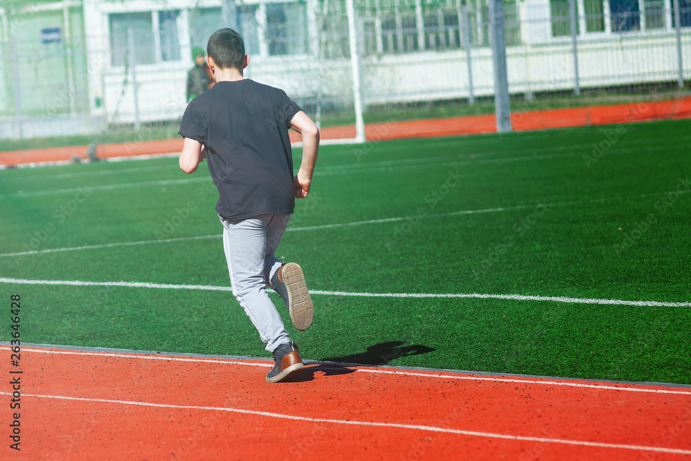 Fototapeta premium Sport man running on a racetrack
