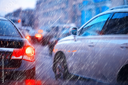 blurred background autumn auto rain on the road / night lights and raindrops in the autumn traffic jam on the road, urban style traffic