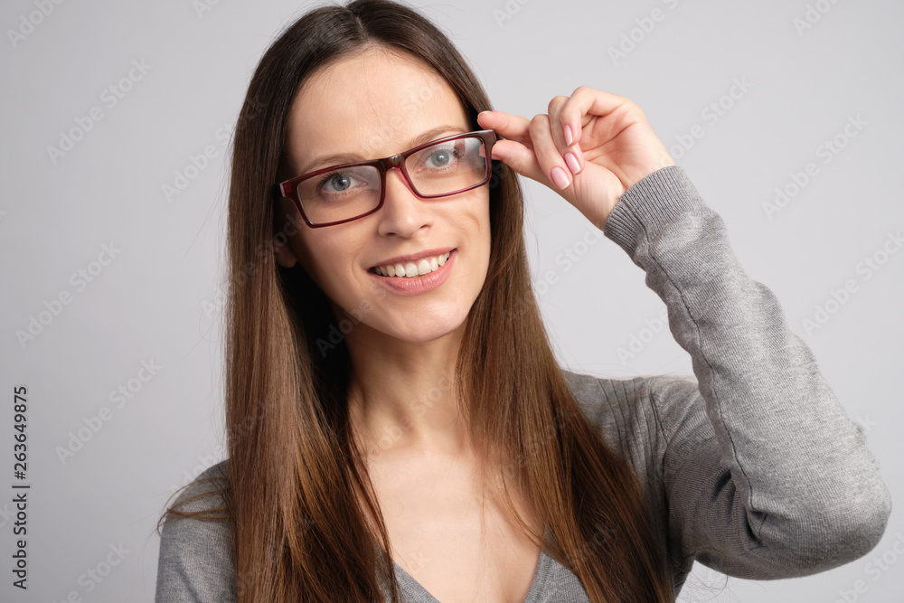 Pretty girl wearing eyeglasses with toothy smile Pretty girl wearing eyeglasses with toothy smile