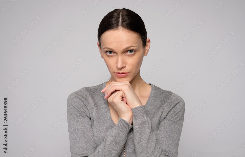 pretty woman looking at camera isolated on grey pretty woman looking at camera isolated on grey
