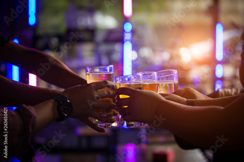 Group of  young people hands toasting and cheering aperitif beers half pint