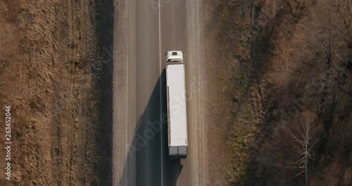 Truck driving / traveling on highway aerial footage at spring time / top view / Highway truck traffic photo