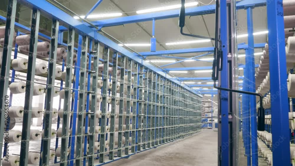 Metal racks with white clews on them at a textile plant. Metal racks with white clews on them at a textile plant.
