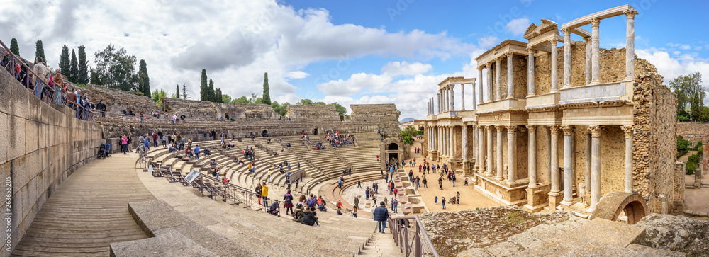 Merida, Spain. April 2019: Tourist crowd in the Antique Roman Theatre in Merida. Panorama image. The Archaeological Ensemble of Merida is declared a UNESCO World Heritage Site Ref 664 - obrazy, fototapety, plakaty 