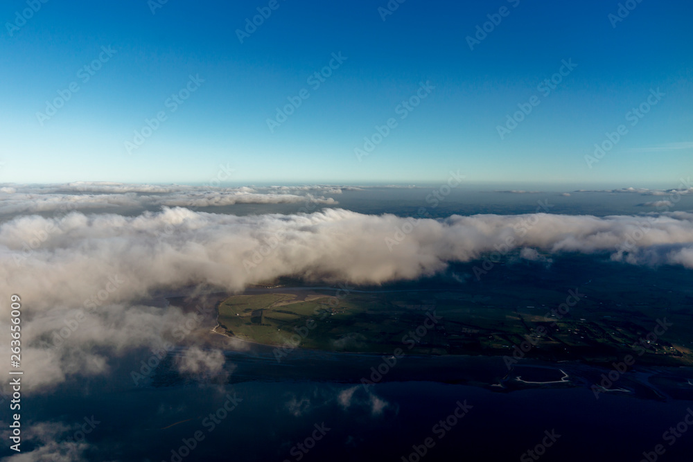 Fototapeta premium Flying above the clouds, view from the airplane, New Zealand