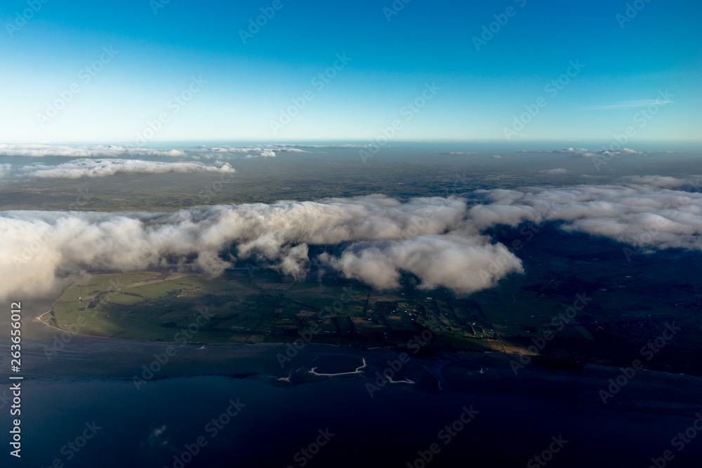 Flying above the clouds, view from the airplane, New Zealand Flying above the clouds, view from the airplane, New Zealand