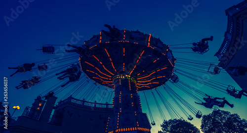 Photography spinning amusement park ride at sunset in vienna