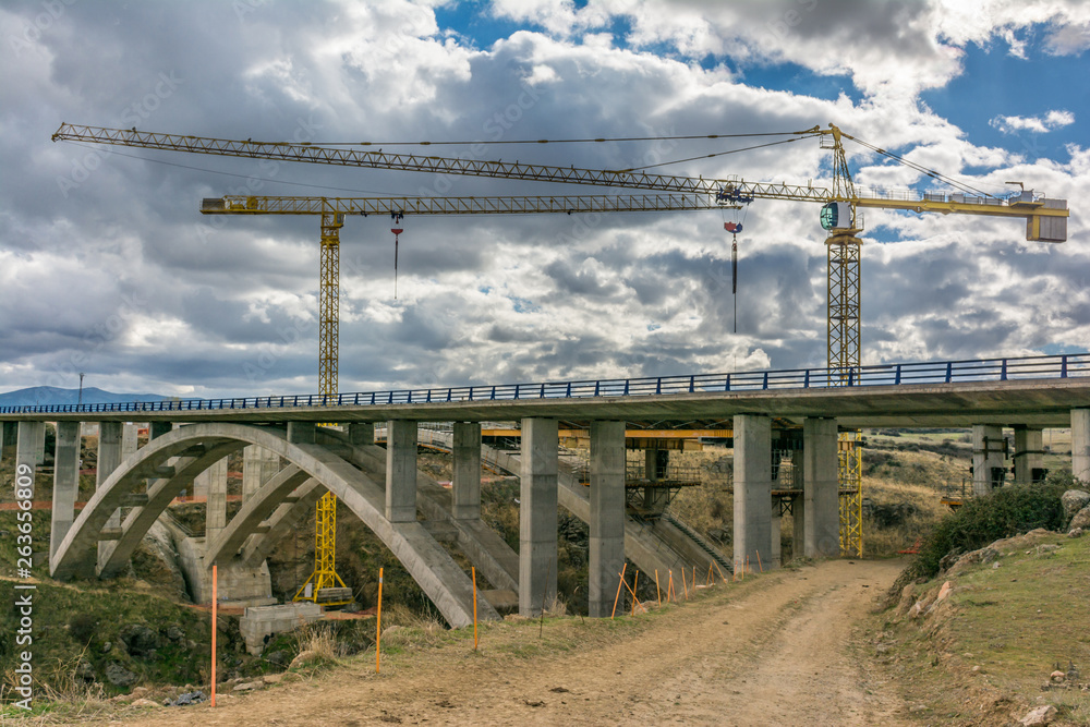 Cranes in the construction of a bridge for a highway