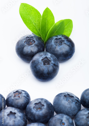 Fresh raw organic blueberries with leaf on white background. Macro close up