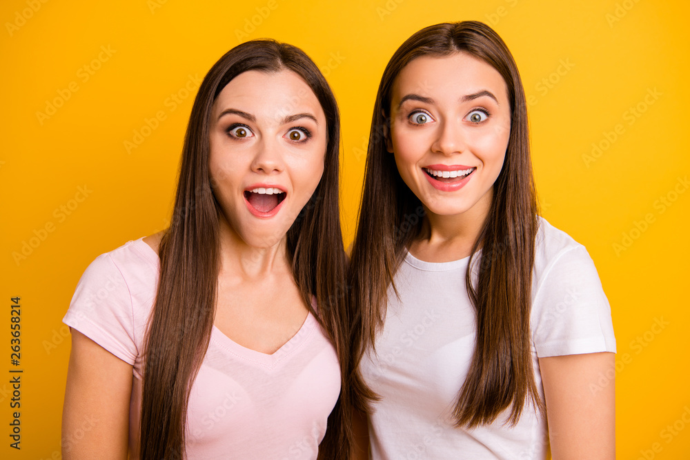 Close up photo two people beautiful funky funny she her ladies models open mouth not believe great amazing news information wear white pink casual t-shirts isolated yellow background Close up photo two people beautiful funky funny she her ladies models open mouth not believe great amazing news information wear white pink casual t-shirts isolated yellow background