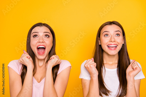 Close up photo cheerful student lucky enjoy incredible unexpected trip news aim luck raise fist isolated scream shout wait want expect dream desire long hair pastel outfit yellow background