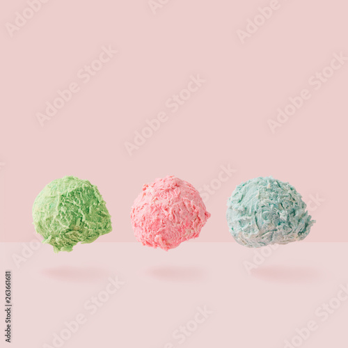 Ice cream scoops against pastel pink background. Minimal summer food concept.