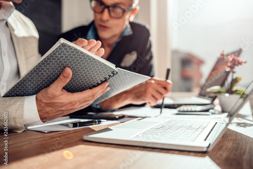 Businessman holding note pad during a meeting