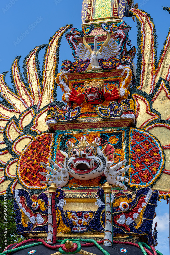 Fototapeta premium Bade cremation tower with traditional balinese sculptures of demons and flowers on central street in Ubud, Island Bali, Indonesia . Prepared for an upcoming cremation ceremony