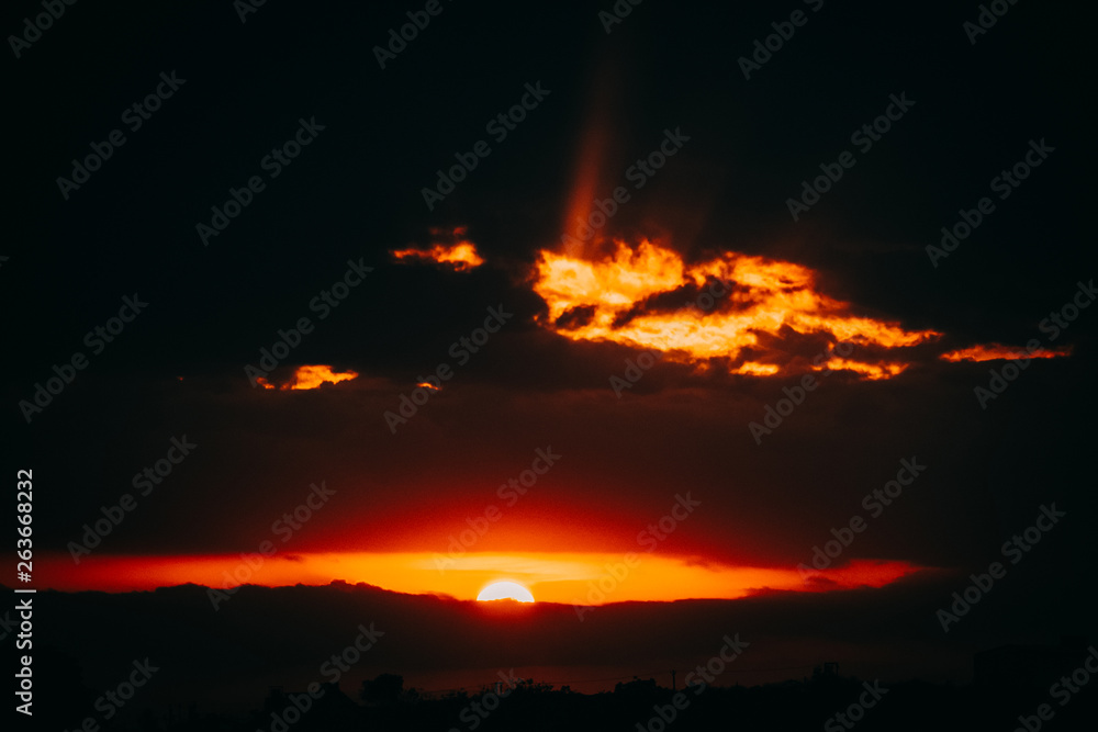Dramatic sunset illuminating the clouds with orange colour Dramatic sunset illuminating the clouds with orange colour