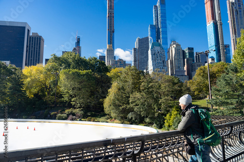 Man looking at empty Ice Rink at Central Park in winter