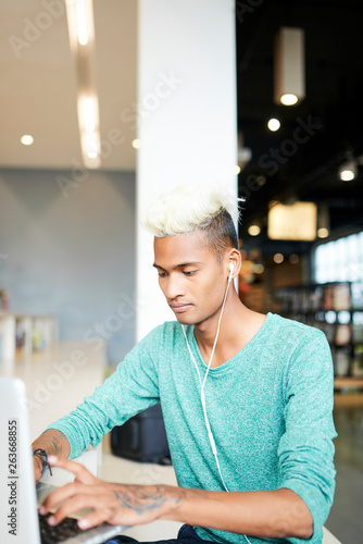 Concentrated guy using wifi in library