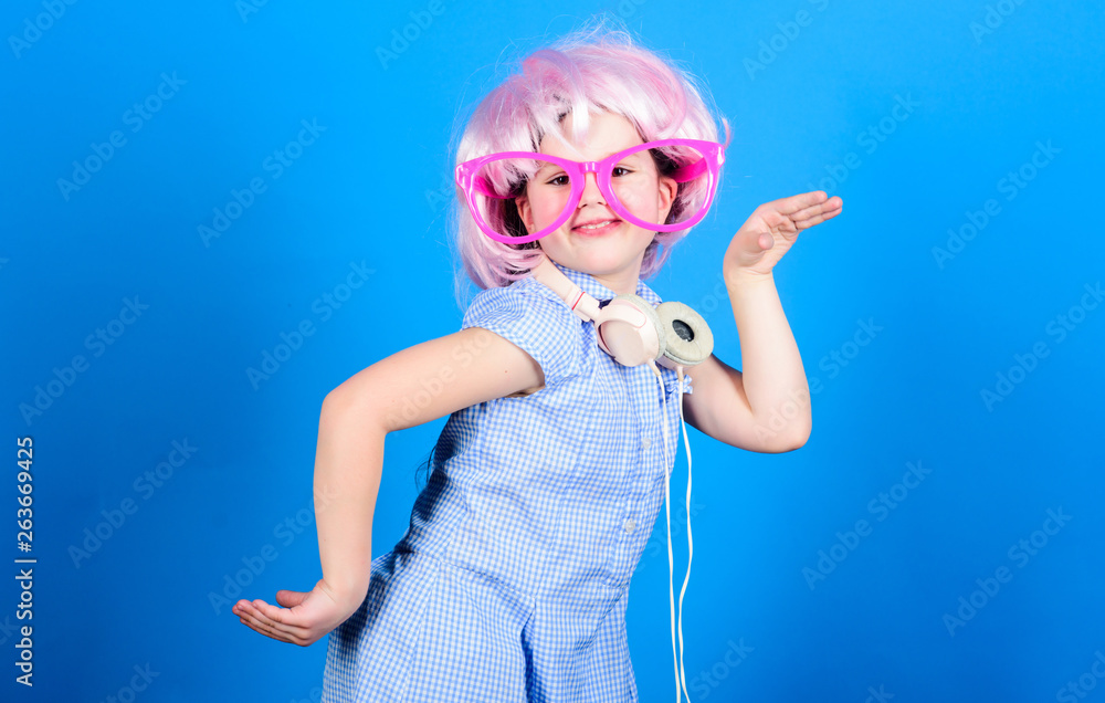 The coolest modern music. Little modern girl in party style wearing bluetooth headphones. Small child enjoy dancing to modern music every day. Using modern technology for pleasure The coolest modern music. Little modern girl in party style wearing bluetooth headphones. Small child enjoy dancing to modern music every day. Using modern technology for pleasure