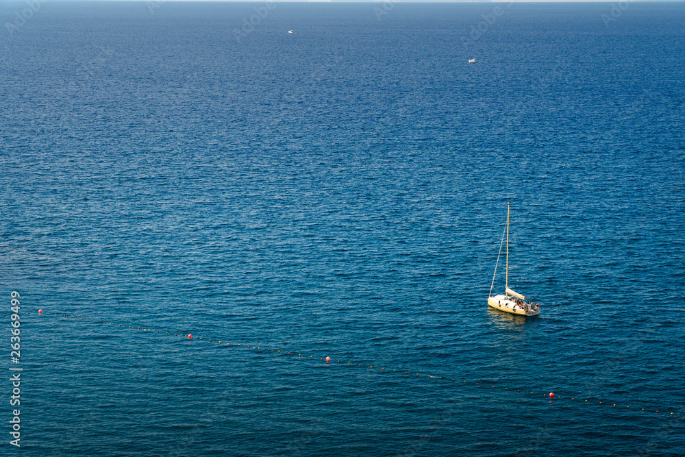Fishing boat floating on the water, blue sea and sky with copyspace
