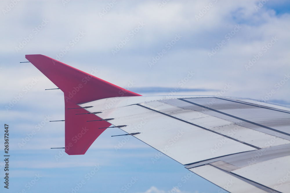 pink airplane wings on blue sky - freedom and travel concept pink airplane wings on blue sky - freedom and travel concept