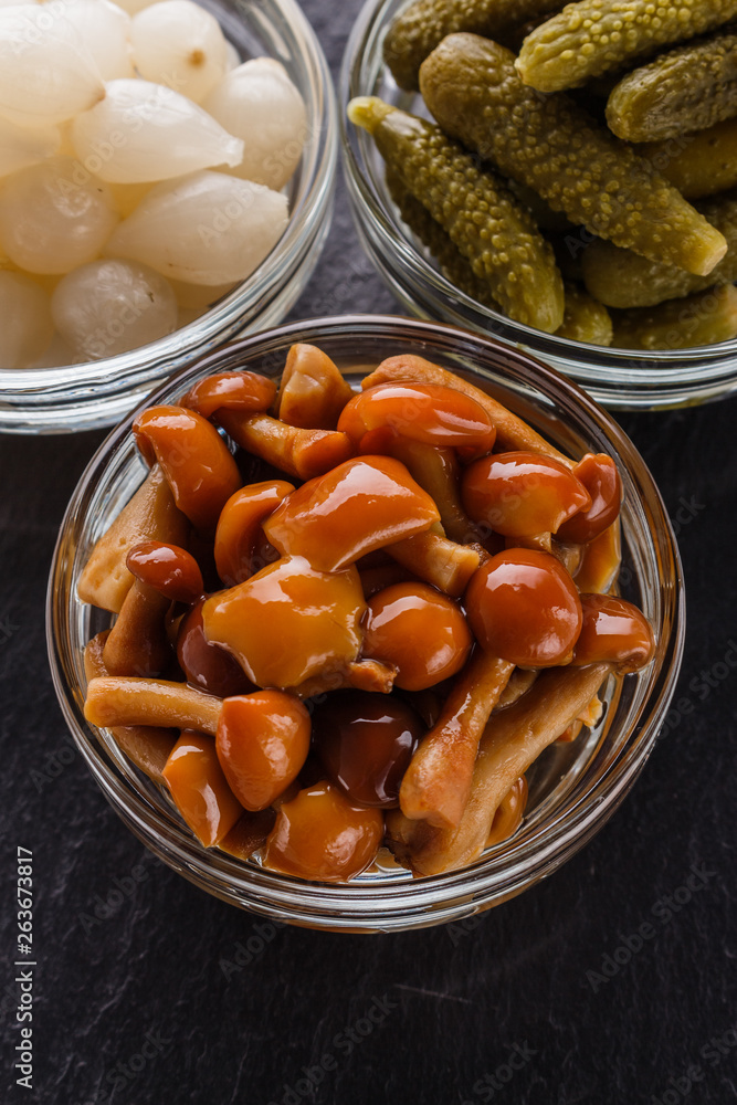 pickled vegetables on a dark stone background pickled vegetables on a dark stone background