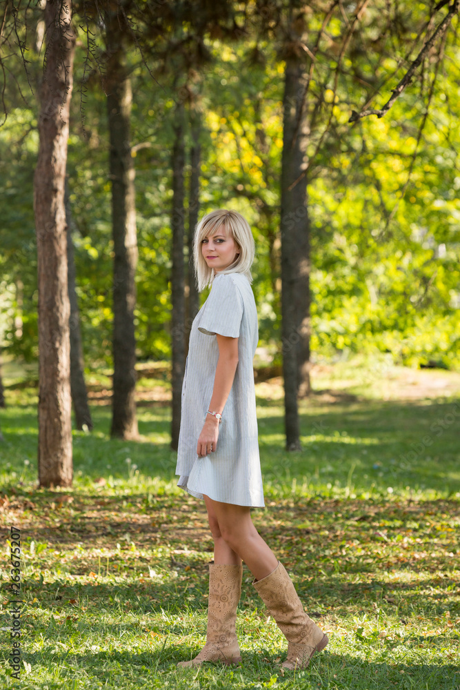 Fashion style portrait of gorgeous beautiful woman posing in summer green park Fashion style portrait of gorgeous beautiful woman posing in summer green park