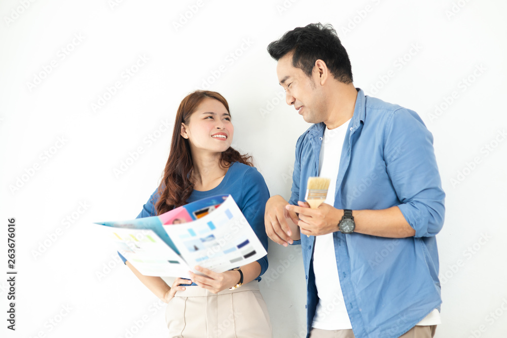 Asian couple choosing colour palette for their new house, lifestyle concept. Asian couple choosing colour palette for their new house, lifestyle concept.